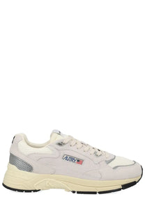 Cream-colored autry men’s sneaker with suede and mesh and gray accents on heel and side panels