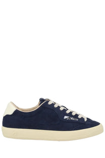 Navy blue suede low-top sneaker with cream laces rubber sole and white logo on the side by Autry