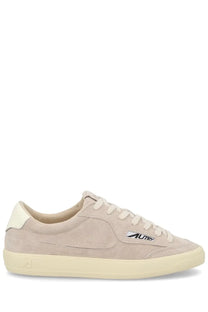 Beige suede autry men’s low-top sneaker with cream laces and sole featuring black autry logo on the side