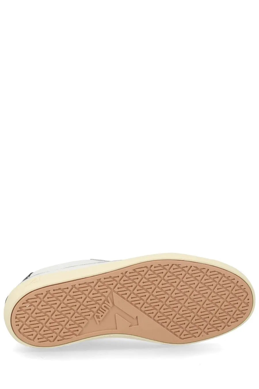 Beige rubber sole with geometric tread pattern and embossed autry logo on men’s windscape low white sneaker