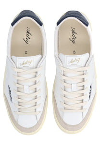 Autry men’s sneaker windscape low white leather with navy heel tabs beige rubber soles and aubry branding on side and insole
