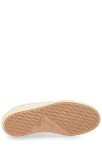 Tan rubber sole with geometric tread pattern and embossed brand logo on autry men’s sneaker windscape low white