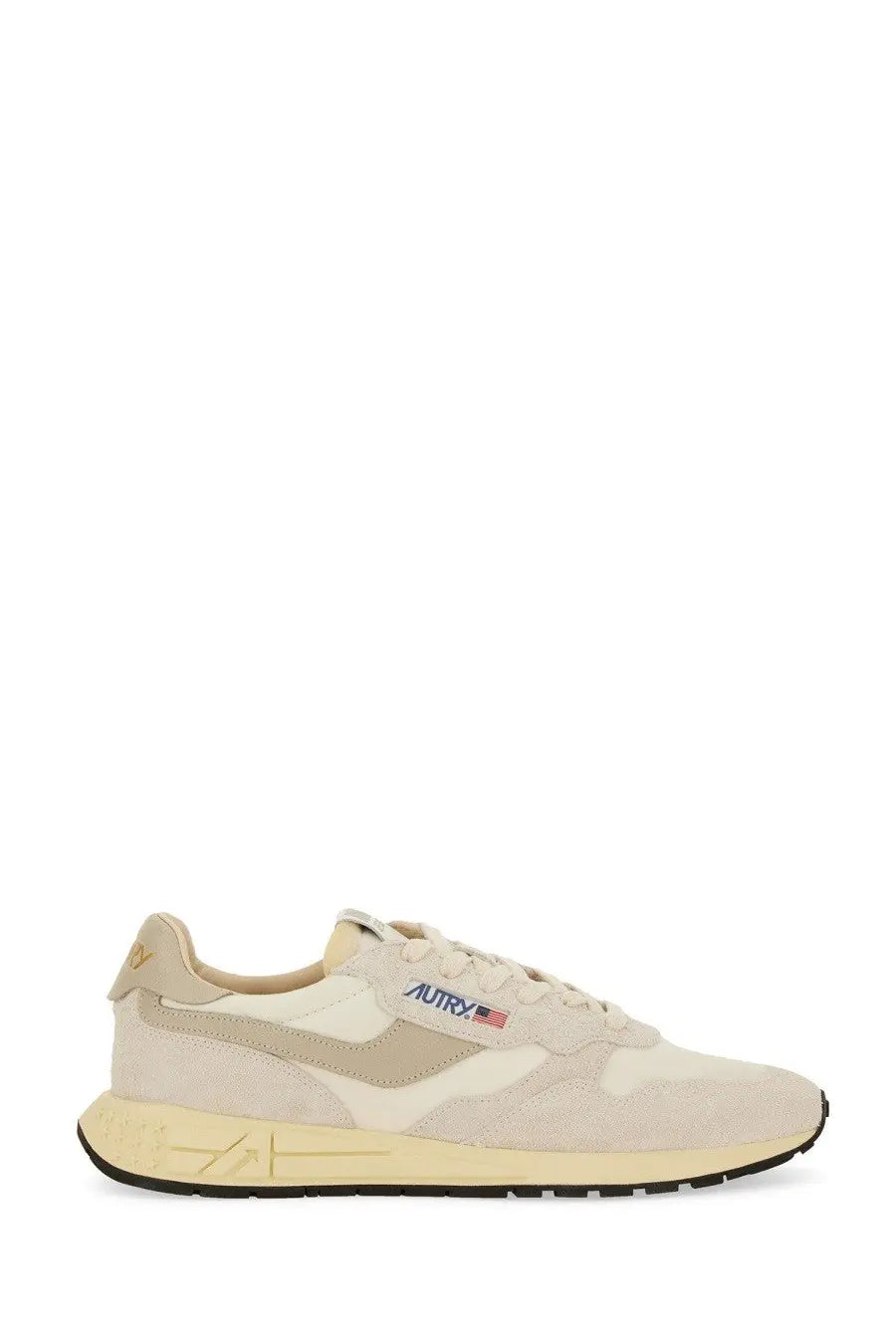 Beige and cream suede autry men’s sneakers with subtle gold heel logo and blue red embroidered brand mark near laces