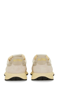 Beige suede autry men’s sneakers reelwind low with pale yellow rubber sole and gold branding on the back heel