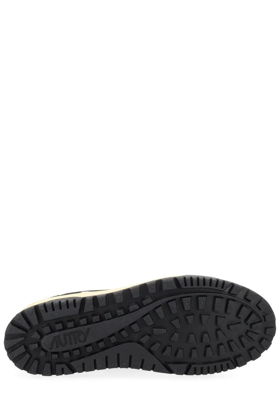 Black rubber sole with textured tread and autry brand name embossed on the center of autry men’s wildpace low sneaker
