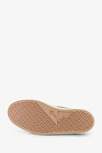 Beige rubber sole with diamond-patterned tread and embossed vans logo on autry men’s windscape canvas sneakers military