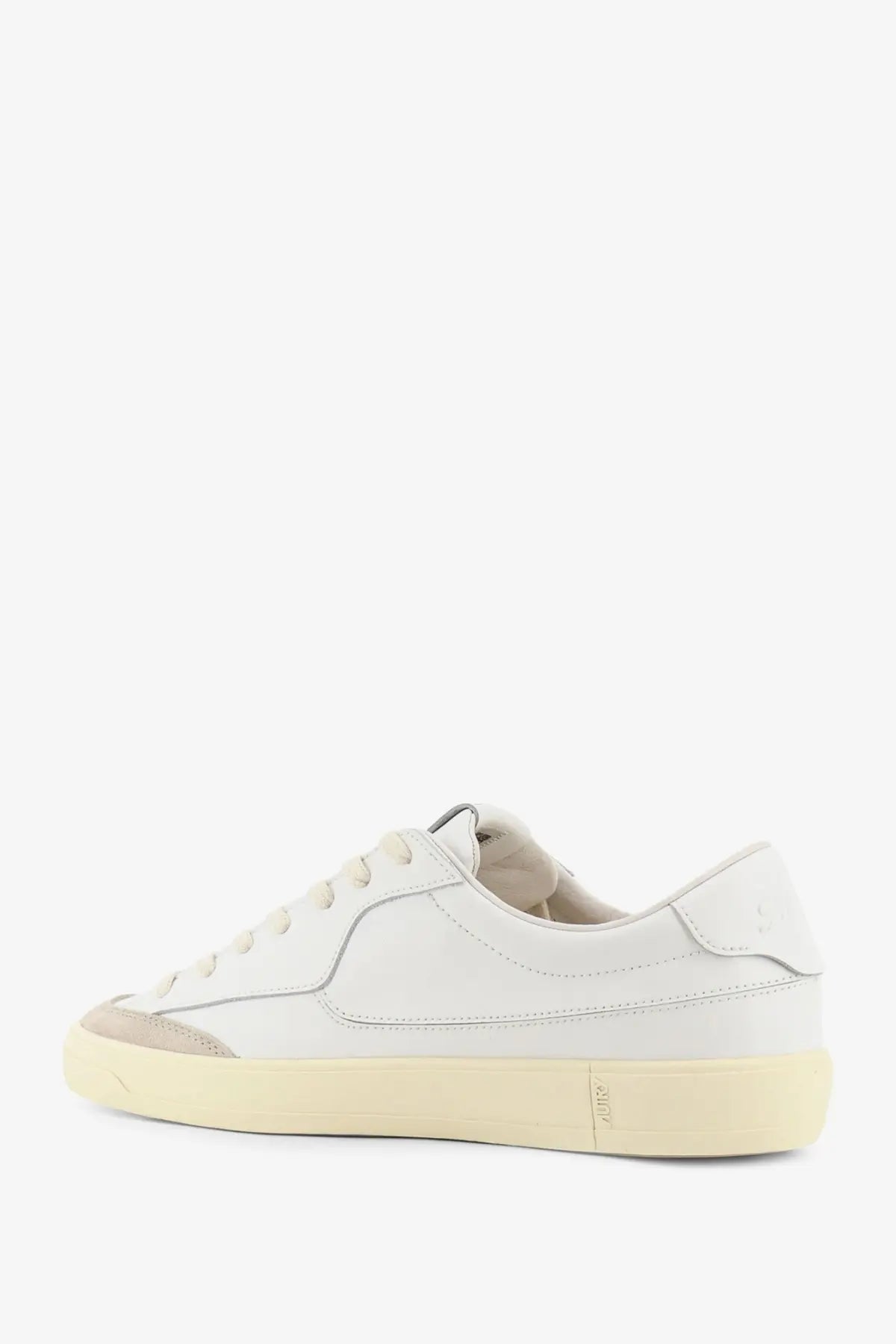 Autry men’s Windscape leather sneakers in white feature low-top design with beige rubber sole and gray toe cap accents