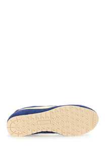 Autry men’s windspin sneaker in blue suede with beige rubber sole and puma brand embossing visible from the back side