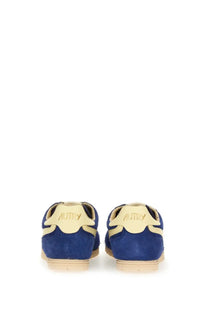 Back view of autry men’s windspin sneaker in blue suede with beige accents and autry logo on the heel