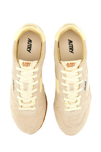Beige suede autry men’s windspin sneaker with cream laces and tan rubber sole showing the insole logo