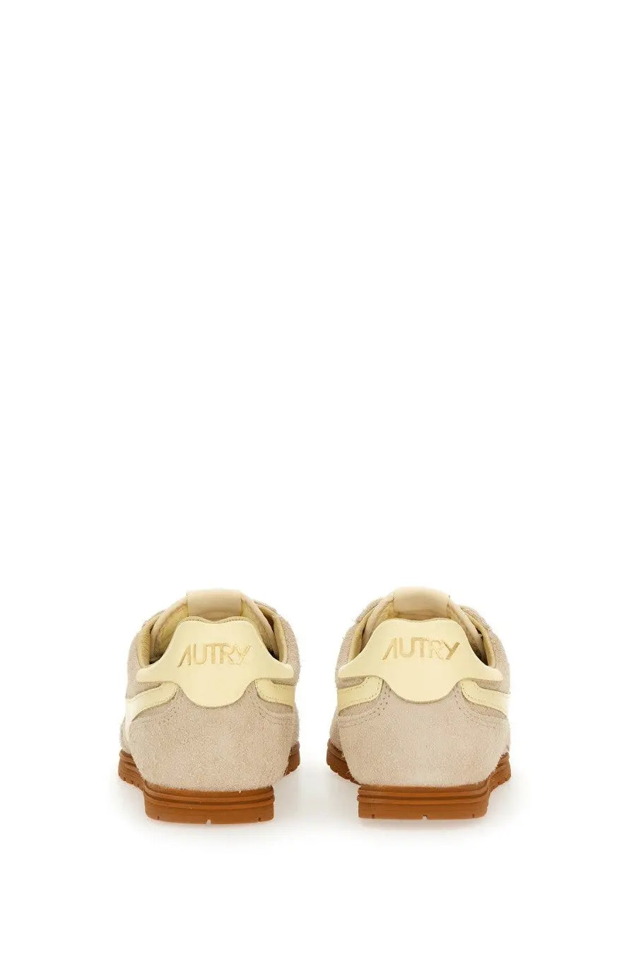 Beige suede autry men’s windspin sneaker with tan rubber sole and cream branding on the heel back side view