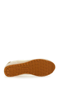 Back view of a cream-colored suede autry men’s windspin sneaker with tan rubber sole and zurix logo on the heel