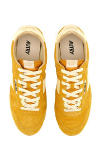 Autry men’s Windspin sneaker in mustard-yellow suede with white laces and classic retro design