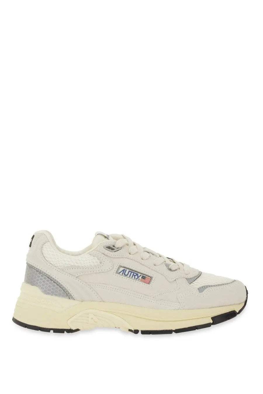 Cream-colored autry women’s hyperway sneaker with gray accents and chunky sole featuring autry logo on the side