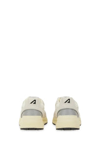 Autry women’s hyperway sneaker white cream-colored with gray mesh panels and black rubber soles minimalist design