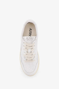 Autry women’s medalist leather sneaker in white with perforated detailing and cream-colored rubber sole
