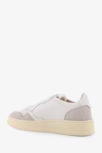 Autry women’s medalist low leather sneaker in white and gray suede with cream rubber sole front view