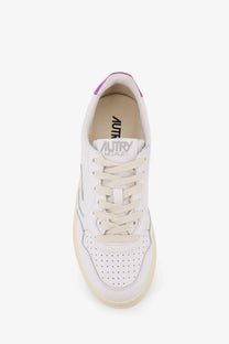 Autry women’s medalist low leather sneaker in white with purple heel tab and perforated toe box