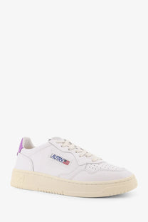 Autry women’s medalist low leather sneaker in white with purple heel tab and american flag embroidered logo on cream sole