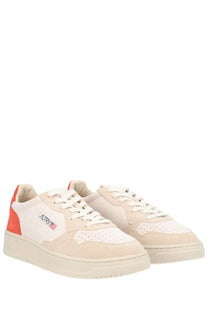 Cream-colored suede and canvas autry women’s medalist low sneaker with bold orange heel tab and logo patch on the side