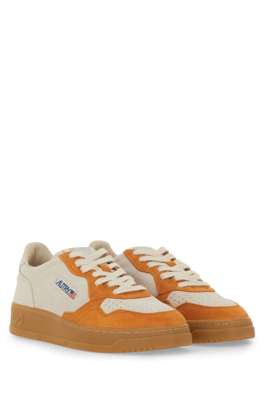 Autry women’s Medalist low sneaker in cream and orange suede with a gum rubber sole for casual wear