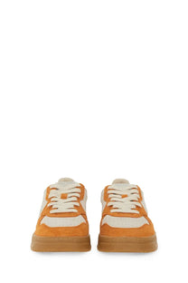 Autry women’s medalist low sneaker in orange and white suede with a gum rubber sole for casual wear