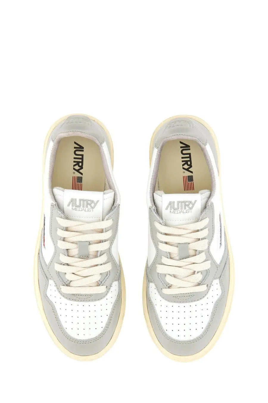 Autry women’s Medalist low sneaker in white and gray with perforated leather uppers cream laces and chunky sole