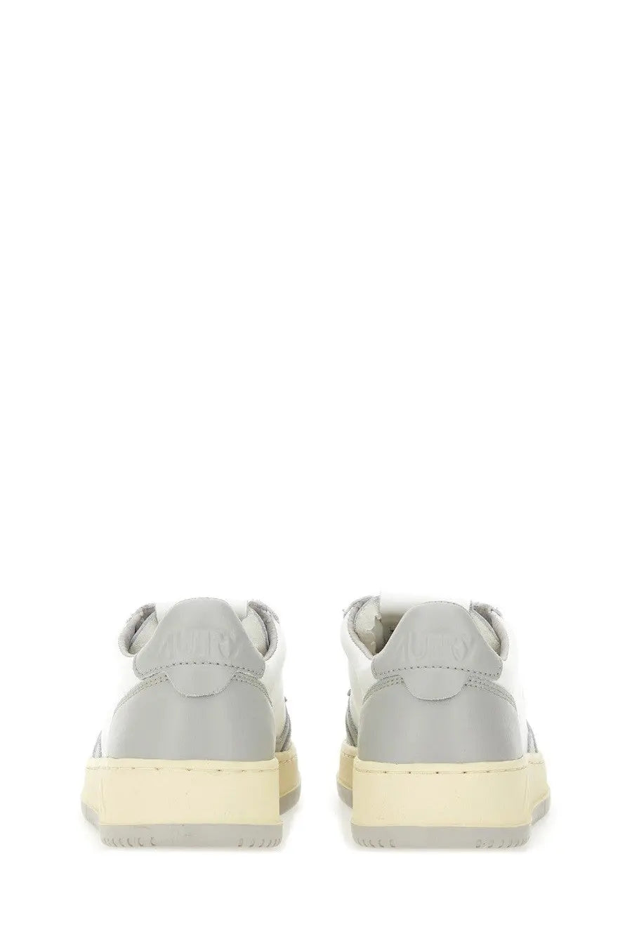 Autry women’s medalist low sneaker in gray and white with a chunky off-white rubber sole for casual wear