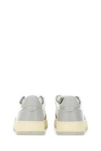 Autry women’s medalist low sneaker in gray and white with a chunky off-white rubber sole for casual wear