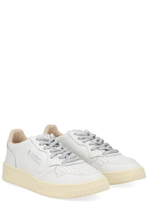 Autry women’s medalist low sneaker is a white leather sneaker with gray laces and a cream rubber sole