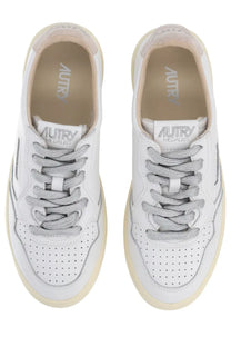 Autry women’s medalist low sneaker in white leather with silver laces cream sole and perforated toe box detailing