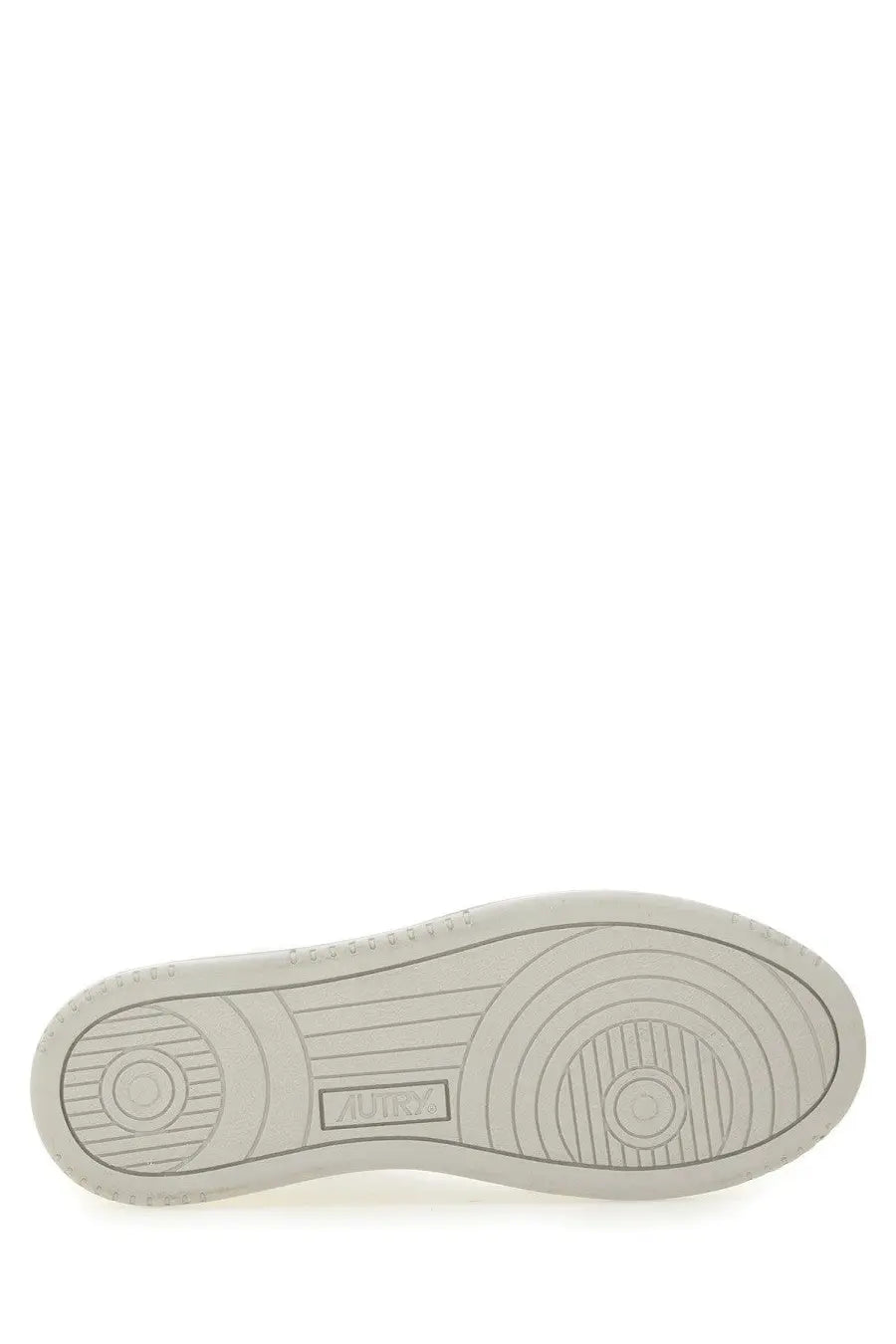 White rubber sole with circular tread patterns and subtle aurora logo on autry women’s medalist low sneaker white