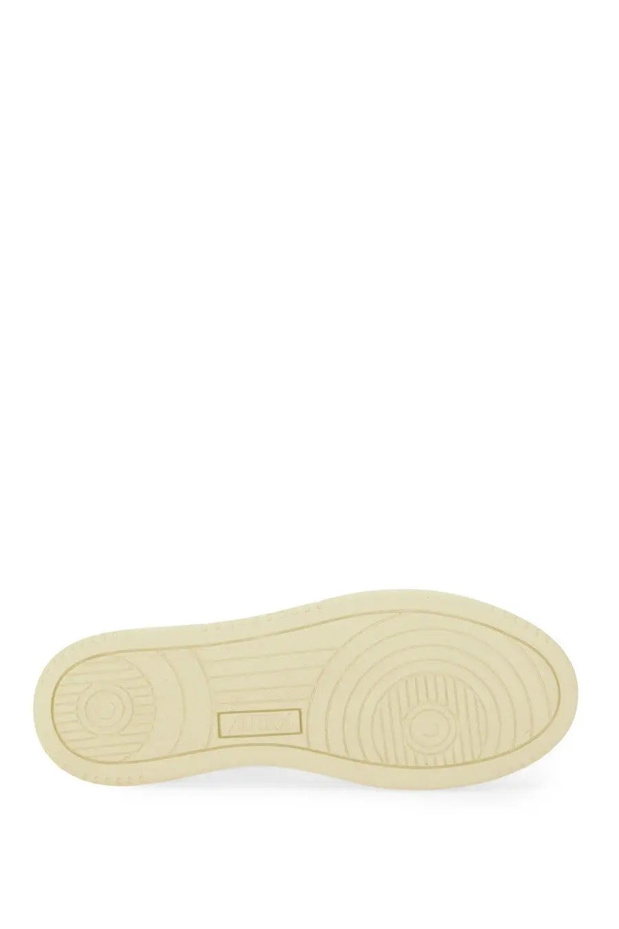 Cream-colored rubber sole of autry women’s medalist low sneaker yellow with circular tread and rectangular logo indentation