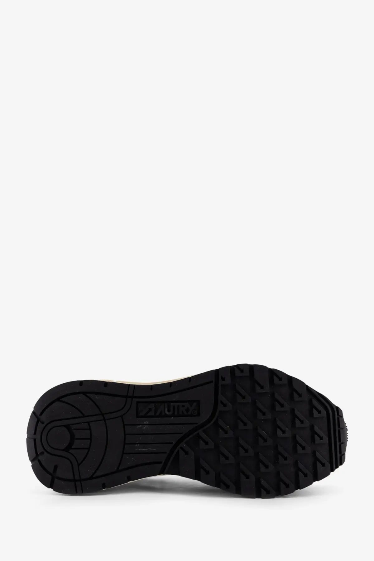 Black rubber sole with textured tread and zuru logo on the side of autry womens reelwind low animal print suede sneakers