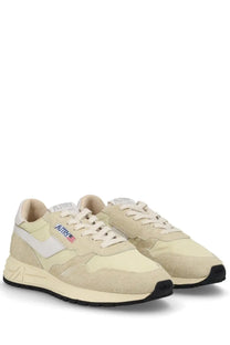 Autry women’s reelwind low sneaker in cream suede and canvas with white swoosh and black rubber sole