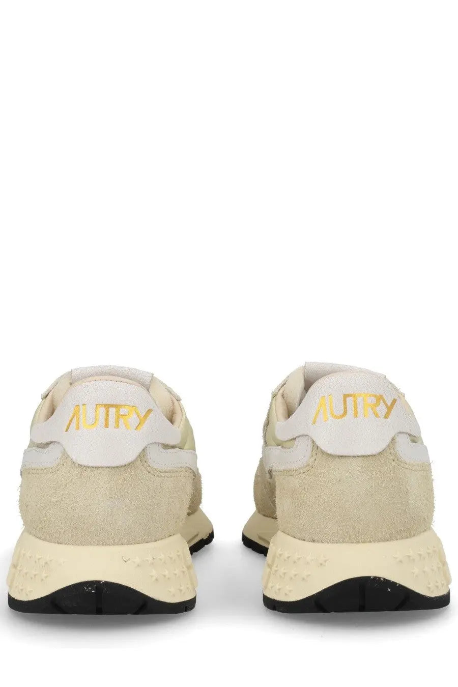 Back view of autry women’s reelwind low sneaker in cream suede with gold branding and black rubber sole