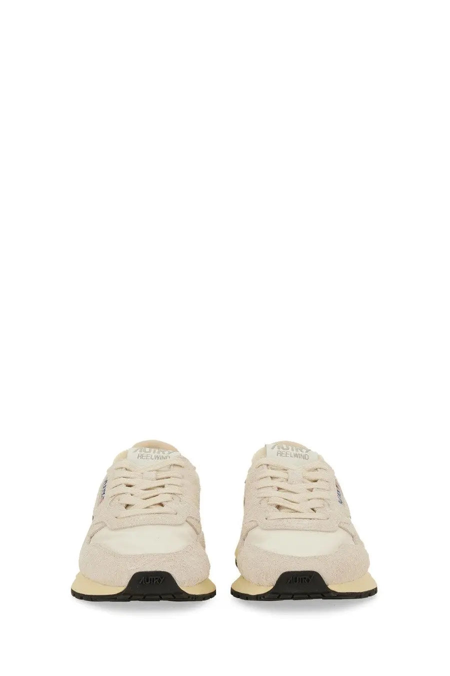 Cream-colored suede and canvas autry women’s reelwind low sneaker white with black rubber soles shown from the back