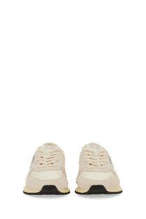 Cream-colored suede and canvas autry women’s reelwind low sneaker white with black rubber soles shown from the back