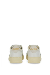 Back view of cream-colored leather autry women’s sneaker medalist low with gold-tone autry branding on the heel