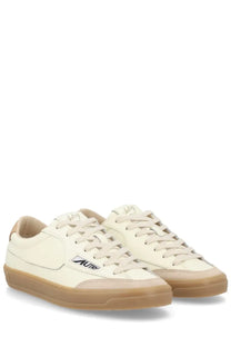 Autry women’s sneaker windscape low white cream leather with tan rubber soles and black branding on the side