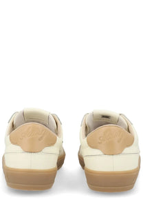Autry women’s sneaker windscape low white featuring cream suede and leather with tan rubber soles and embossed logo on heel back