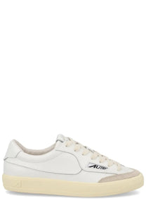 Autry women’s sneaker windscape low white leather sneaker with beige rubber sole and subtle gray accents