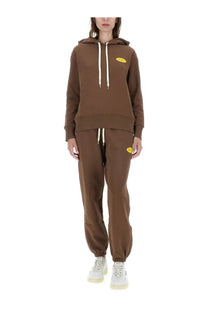 Autry women’s sweatshirt brown with white drawstrings and yellow oval logo paired with matching brown joggers