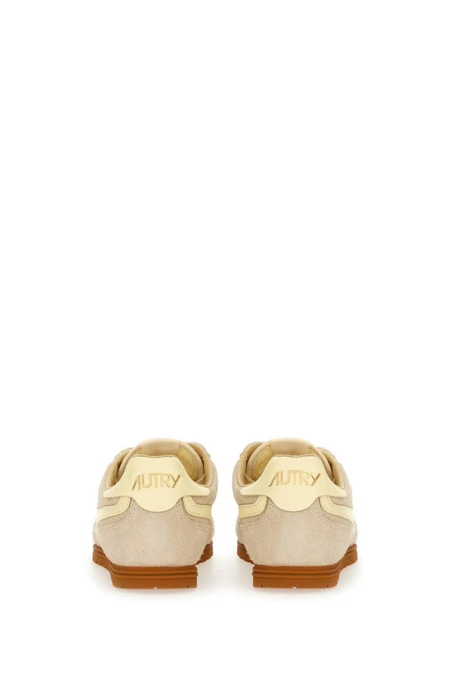 Beige suede autry women’s windspin low sneaker with tan rubber sole showing the back side branding