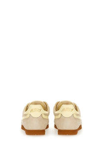Beige suede autry women’s windspin low sneaker with tan rubber sole showing the back side branding