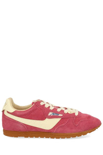 Autry women’s windspin low sneaker in pink suede with cream accents and tan rubber sole featuring autry logo