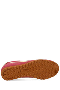 Autry women’s windspin low sneaker in pink suede with a tan rubber sole and embossed brand name on the side