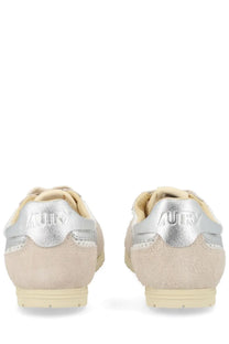 Beige suede autry women’s windspin sneakers with silver metallic heel tabs and cream rubber soles back view