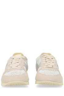 Autry women’s Windspin sneaker in beige and white perforated suede with subtle gray side accent