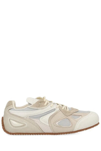 Axel Arigato men’s Slow Runner sneaker in white with beige suede overlays mesh panels and brown rubber sole